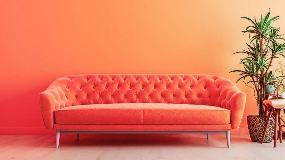 Designers are using a "punchy orange" hue to bring a "happy" element to sofas, Fashion Snoops said.