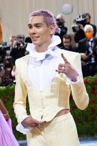 Evan Mock wore a Cartier necklace, ear cuffs, earrings, brooch and rings