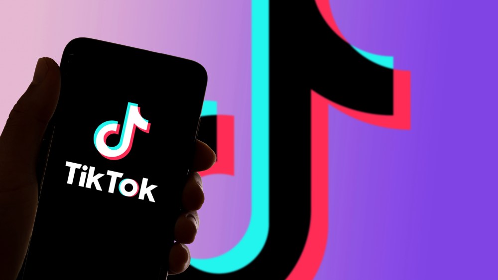 In this photo illustration the logo of the social network TikTok is seen on the screen of mobile phone and of a laptop in Barcelona, Spain on November 4, 2021. (Photo by Davide Bonaldo/Sipa USA)(Sipa via AP Images)