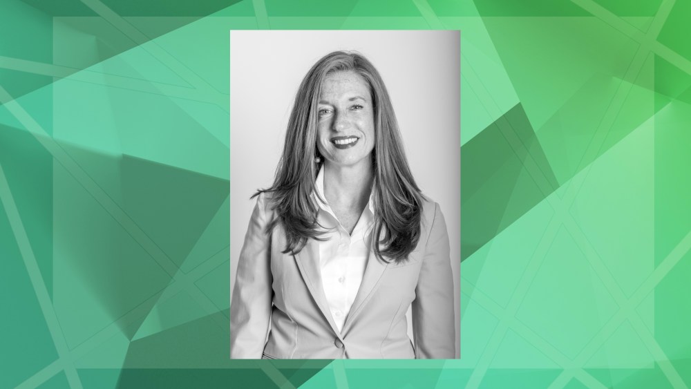 A greyscale headshot photo of Accenture's Cara Smyth against a green geometric background.