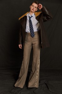 Jil Sander’s calf leather jacket over Loro Piana’s linen shirt, and Sacai’s wool pants. Versace platform boots; Emporio Armani tie; Etiq earrings.