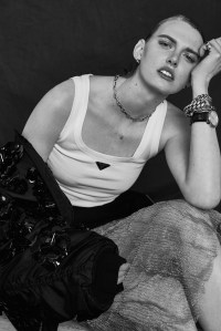 Prada’s cotton tank, Re-Nylon and ricamo jacket and double wool and mesh skirt. Etiq earrings; Bulgari watch; David Yurman necklace and bracelet; Louis Vuitton bracelet; Vitali bracelet; Ali Grace signet ring; Reframed Jewellery signet ring.