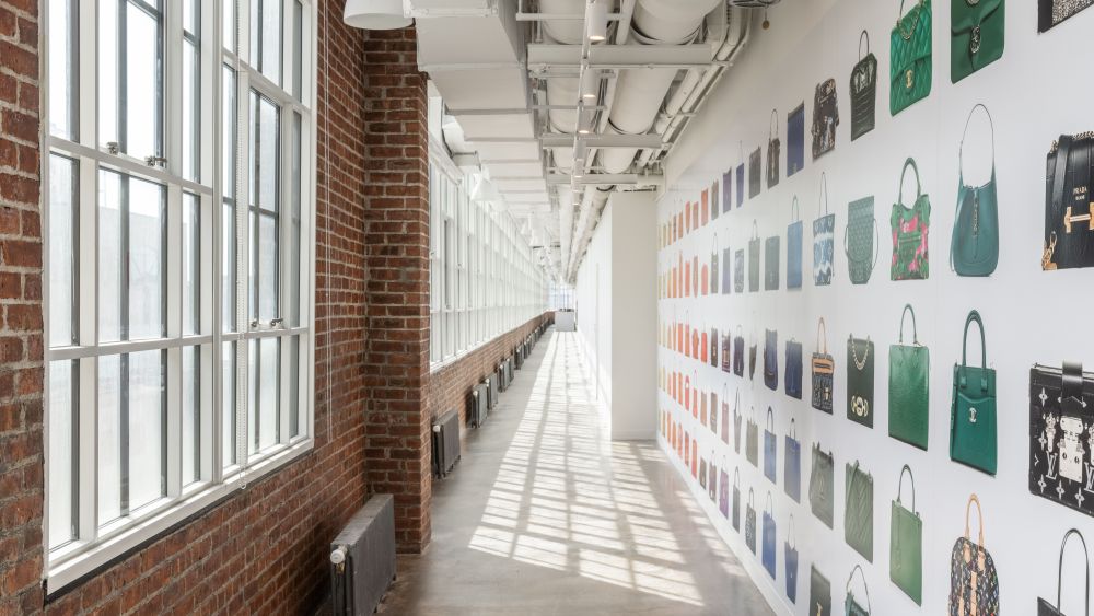 The rainbow display wall of Fashionphile bags in its light-filled East Coast headquarters.
