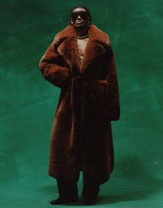 Adrienne Landau by Saulo Villela faux fur coat and Koché’s virgin wool pants. Gucci sunglasses; Saint Laurent boots. Alexis Bittar necklace