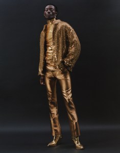 Celine Homme by Hedi Slimane’s teddy jacket in embroidered satin nylon, embroidered cotton jersey turtleneck tee and metallic satin pants. Celine Homme by Hedi Slimane boots.