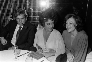 John Warner, Elizabeth Taylor, and Regine Zylberberg attend a party at Regine's nightclub, 1976.
