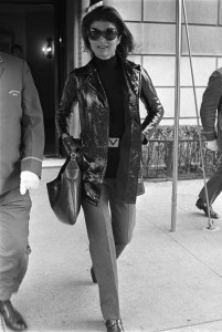 Jackie Onassis wearing a leather coat and Valentino belt, leaving her apartment building in New York on October 1, 1970.