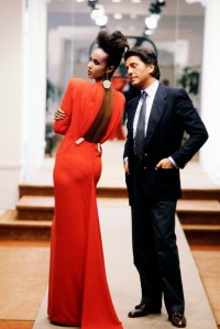 Valentino poses with Iman in a signature red couture evening gown from the Valentino Fall 1984 Couture collection.