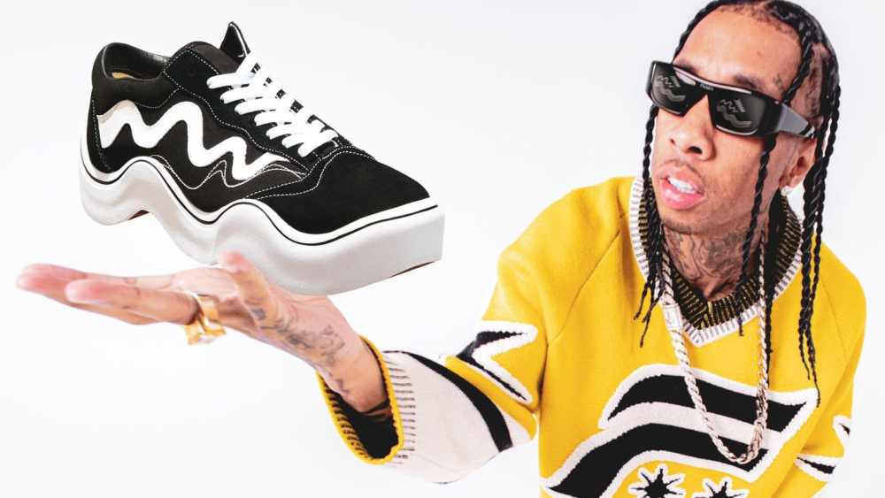 Tyga holding a Wavy Baby sneaker, who collaborated with MSCHF on the design and development of the product.
