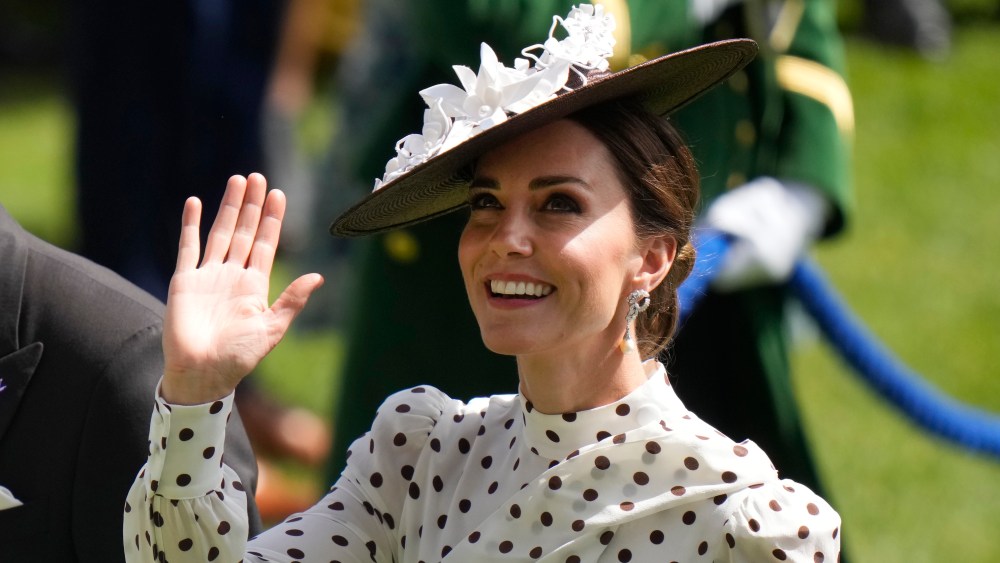 Kate, Duchess of Cambridge waves to the crowd as she walks in the parade ring on the fourth day of the Royal Ascot horserace meeting, at Ascot Racecourse, in Ascot, England, Friday, June 17, 2022. (AP Photo/Alastair Grant)