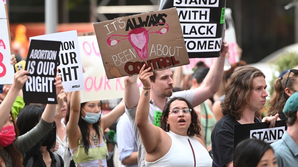 Abortion rights demonstrators hold signs up as they march down University Place during a protest in response to the US Supreme Court's decision to overturn Roe v. Wade, New York, NY, June 24, 2022. The ruling by the US Supreme Court wipes out the constitutional right to abortion set in 1973, and could render the procedure largely illegal in half the country. (Photo by Anthony Behar/Sipa USA)(Sipa via AP Images)
