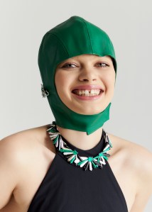 Colette’s 18-karat gold Penacho earrings and necklace with Muzo emeralds, malachite, onyx and diamonds. Alejandra Alonso Rojas balaclava. Zimmermann maillot.