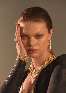 Pomellato’s Iconica earrings in 18-karat rose gold and diamonds. Roberto Coin’s bracelets. Large bracelet: New Barocco 18-karat yellow gold bracelet with diamonds. Smaller bracelet: Obelisco 18-karat yellow gold with accent diamonds. Uniform Object’s pavé knuckle ring in 18-karat yellow gold. Vendorafa’s multistrand necklace in 18-karat yellow gold, hand-cast oval link multistrand chain with white diamonds set in 18-karat white gold. Vendorafa’s Ona collar link necklace in 18-karat hand-hammered gold connecting overlapping links with white diamonds set in 18-karat white gold. Roxy swimsuit.