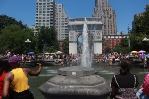 Explicatives denouncing SCOTUS are the focal point of Washington Square Park fountain where Pride-goers gather to cool off.