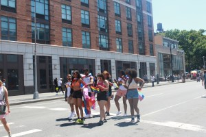A pack of young women dance in the streets at NYC Pride.