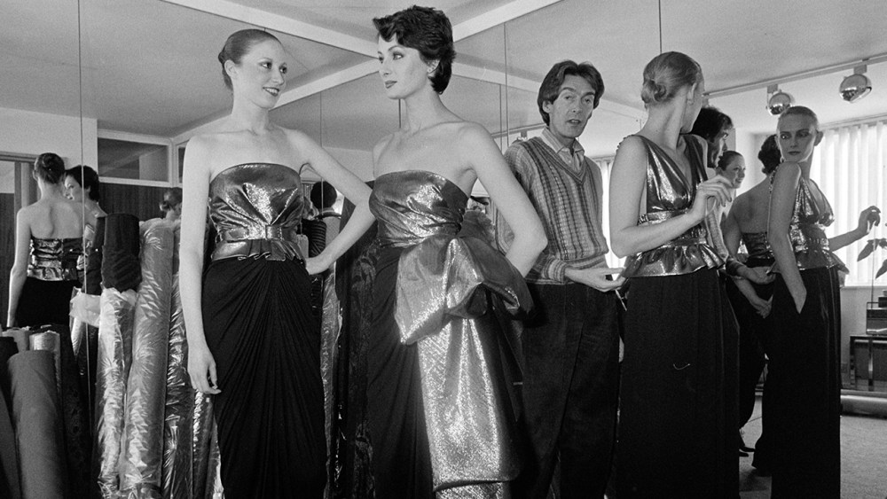 Designer John Bates fits models at a Fall 1980 Ready to Wear Advance Preview.