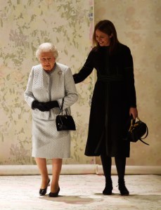 Queen Elizabeth II and an escort attend the Richard Quinn fall 2018 ready to wear collection fashion show in London on February 17, 2020.