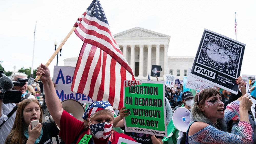Anti-abortion and abortion-rights protesters gather outside the Supreme Court in Washington, Friday, June 24, 2022.