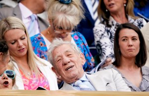 Actor Sir Ian McKellen, center, takes his seat on Centre Court on day eight of the Wimbledon tennis championships in London, Monday, July 4, 2022. (AP Photo/Alberto Pezzali)