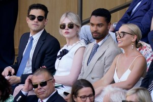 Actors Rami Malik, Lucy Boynton, Rene-Jean Page and Emily Brown, from left, sit in the Royal Box on Centre Court to watch Serbia's Novak Djokovic and Britain's Cameron Norrie in a men's singles semifinal on day twelve of the Wimbledon tennis championships in London, Friday, July 8, 2022. (AP Photo/Gerald Herbert)