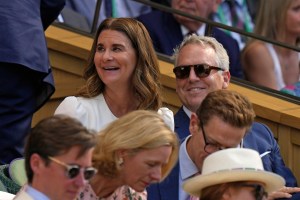 Melinda French Gates, center, sits in the Royal Box on Centre Court to watch Serbia's Novak Djokovic and Britain's Cameron Norrie in a men's singles semifinal on day twelve of the Wimbledon tennis championships in London, Friday, July 8, 2022. (AP Photo/Alastair Grant)