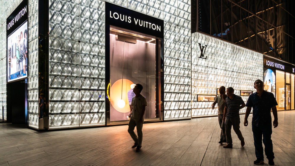 Residents walking past a Louis Vuitton store in downtown Shanghai.
