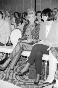 Ivana Trump wearing a Dior pantsuit laughing with a friend during the Adolfo fall 1990 Ready-To-Wear collection on June 13, 1990 in New York...Article title: 'RTW / Sportswear: Adolfo's a Coco Nut