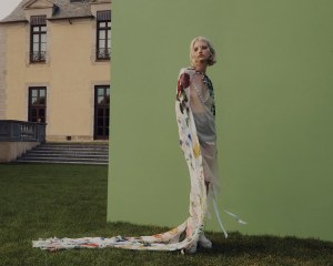 Oscar de la Renta's chiffon cape over Simone RochaÕs tulle dress with pearl and crystal beading and cable-knit briefs with pearl and crystal beading. Gucci platforms; Lafayette 148 socks; Chanel necklace; Joomi Lim earring; Zaxie by Stefanie Taylor earring; R.J. Graziano cocktail ring; Anna Beck ring; IVI ring; Eriness rings; Yi Collection ring.