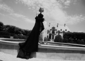 Carolina HerreraÕs silk faille gown; ChanelÕs glitter fantasy tweed topcoat and ring. Jennifer Behr headpiece; Hunter boots; Simone Rocha socks.