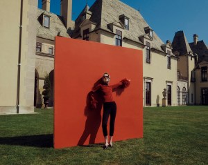 JW Anderson's viscose and acetate jumper and Chanel's wool jersey pants. Prada slides; Christian Dior silk scarf; Tory Burch sunglasses.