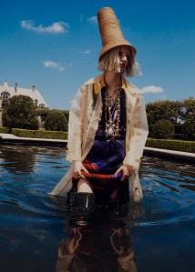 Rejina Pyo's clear crinoline coat over Plan C's polyester sequins, cotton and nylon top; Marine Serre's wool skirt. Esenchel hat; Hunter boots; Chanel necklaces and ring.