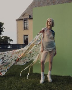 Oscar de la Renta's chiffon cape over Simone Rocha's tulle dress with pearl and crystal beading and cable-knit briefs with pearl and crystal beading. Gucci platforms; Lafayette 148 socks; Chanel necklace; Joomi Lim earring; Zaxie by Stefanie Taylor earring; R.J. Graziano cocktail ring; Anna Beck ring; IVI ring; Eriness rings; Yi Collection ring.