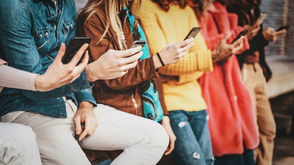 Group of young people using smartphone and social network applications