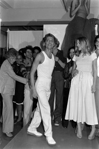Designer Giorgio di Sant' Angelo on stage with guest during the finale of his spring 1977 menswear collection fashion show presentation.