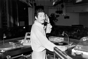 Designer Issey Miyake signs a copy of his book "East Meets West" during pre-setup for his fashion show and celebration of Studio 54's Anniversary party, 1978.