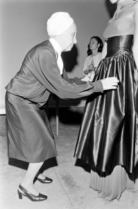 Alix Gres adjusts a look on a model before a fashion show at the Hotel Pierre in New York on October 04, 1978.