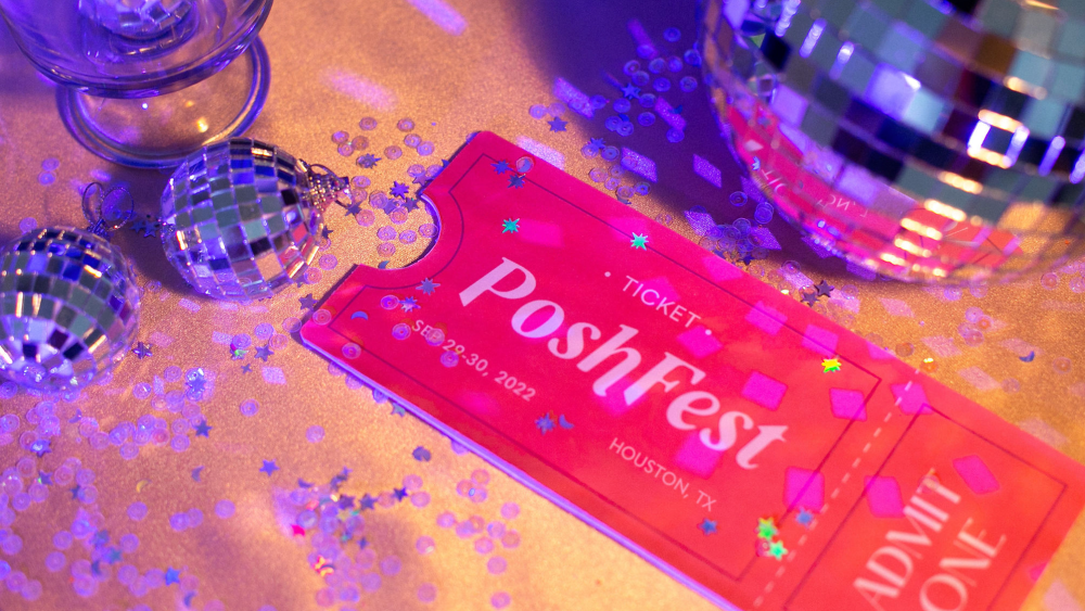 A confetti-strewn table has a disco ball and an admit one ticket for Poshfest 2022 on Sept. 29 to 30.