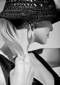 Prada’s silk top and hat, Nikos Koulis’ 18-karat gold earrings with white diamonds and black enamel, Demarson brass rings with pavé Swarovski crystals.
