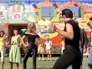 LOS ANGELES - JUNE 16: The movie "Grease", directed by Randal Kleiser. Seen here from left, Olivia Newton-John (wearing tight black) as Sandy and John Travolta (back to camera) as Danny Zuko singing 'You're the One That I Want.'  Initial theatrical release of the film, June 16, 1978. Screen capture. Paramount Pictures. (Photo by CBS via Getty Images)