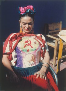 Frida Kahlo revealing her corset painted under her huipil by Florence Arquin, ca. 1951.