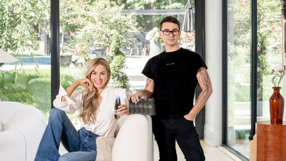 Christian Siriano and BeautyBio's Jamie O’Banion with the limited-edition GloFacial device and matching clutch.