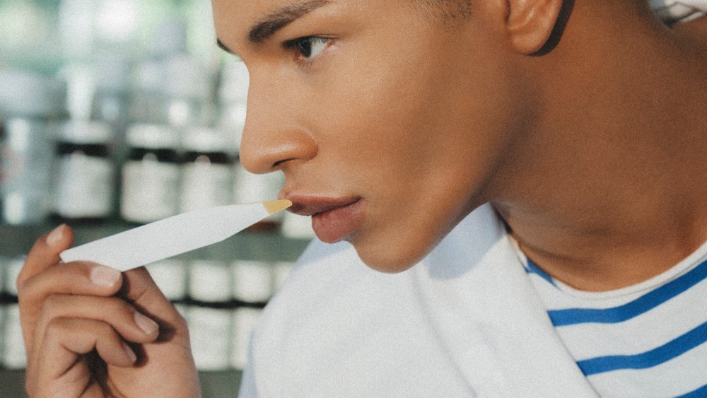 Balmain's Olivier Rousteing sampling a fragrance.