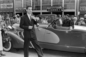 A model poses with a vintage car during a promotional event for Monogram by Ralph Lauren men's fragrance launch at Bloomingdale's New York on April 1, 1985. The fragrance was created by Ralph Lauren and Warner Cosmetics.