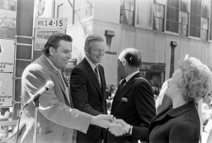 Mayor John Lindsay, Saul Nimowitz, director Apparel Industry Planning and Development, greet designer Molly Pranis and guest during the Fifth Avenue Fashion Fair, 1972.