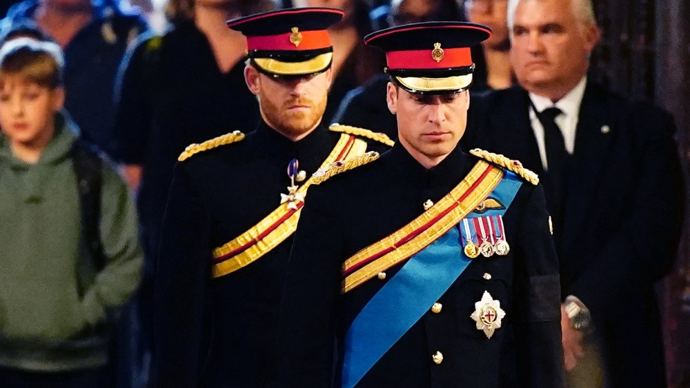 Queen Elizabeth II 's grandchildren (L-R) Britain's Prince Harry, Duke of Sussex (L) and Britain's Prince William, Prince of Wales (R) arrive to hold a vigil around the coffin of Queen Elizabeth II, in Westminster Hall, at the Palace of Westminster in London on September 17, 2022, ahead of her funeral on Monday. - Queen Elizabeth II will lie in state in Westminster Hall inside the Palace of Westminster, until 0530 GMT on September 19, a few hours before her funeral, with huge queues expected to file past her coffin to pay their respects. (Photo by Aaron Chown / POOL / AFP) (Photo by AARON CHOWN/POOL/AFP via Getty Images)