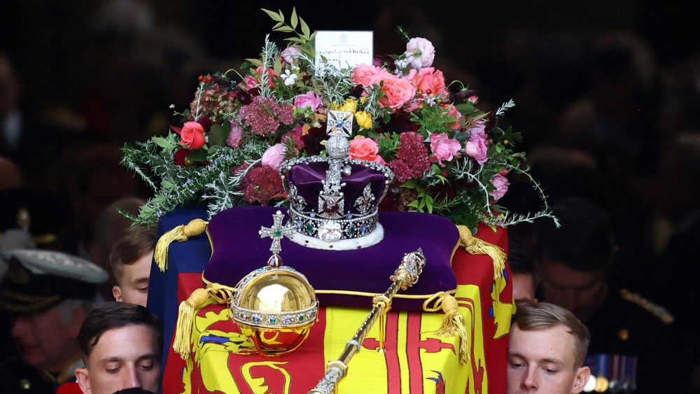 LONDON, ENGLAND - SEPTEMBER 19: Flowers and the Imperial State Crown are seen on the coffin as it leaves Westminster Abbey after the State Funeral of Queen Elizabeth II on September 19, 2022 in London, England.  Elizabeth Alexandra Mary Windsor was born in Bruton Street, Mayfair, London on 21 April 1926. She married Prince Philip in 1947 and ascended the throne of the United Kingdom and Commonwealth on 6 February 1952 after the death of her Father, King George VI. Queen Elizabeth II died at Balmoral Castle in Scotland on September 8, 2022, and is succeeded by her eldest son, King Charles III. (Photo by Hannah McKay - WPA Pool/Getty Images)