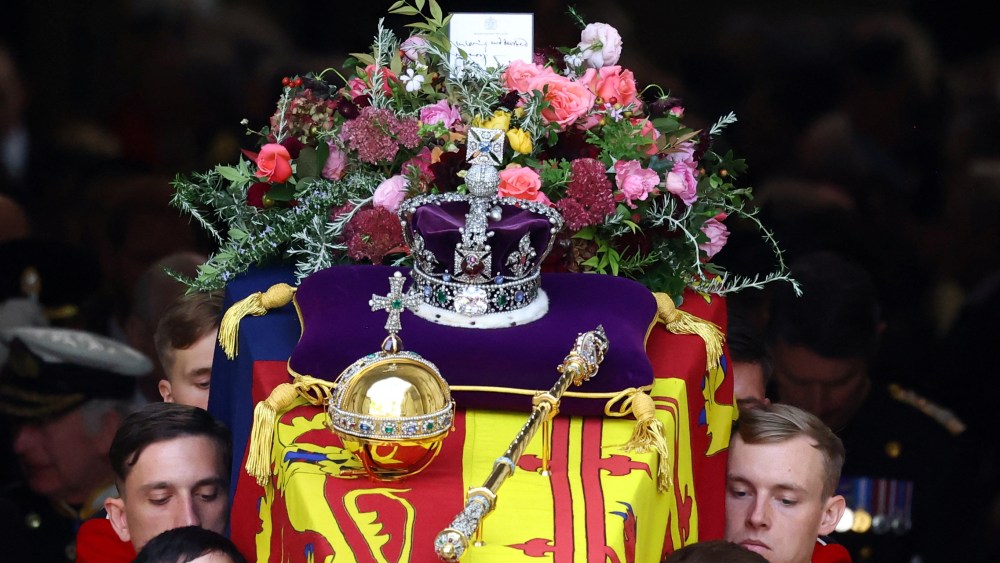 LONDON, ENGLAND - SEPTEMBER 19: Flowers and the Imperial State Crown are seen on the coffin as it leaves Westminster Abbey after the State Funeral of Queen Elizabeth II on September 19, 2022 in London, England.  Elizabeth Alexandra Mary Windsor was born in Bruton Street, Mayfair, London on 21 April 1926. She married Prince Philip in 1947 and ascended the throne of the United Kingdom and Commonwealth on 6 February 1952 after the death of her Father, King George VI. Queen Elizabeth II died at Balmoral Castle in Scotland on September 8, 2022, and is succeeded by her eldest son, King Charles III. (Photo by Hannah McKay - WPA Pool/Getty Images)