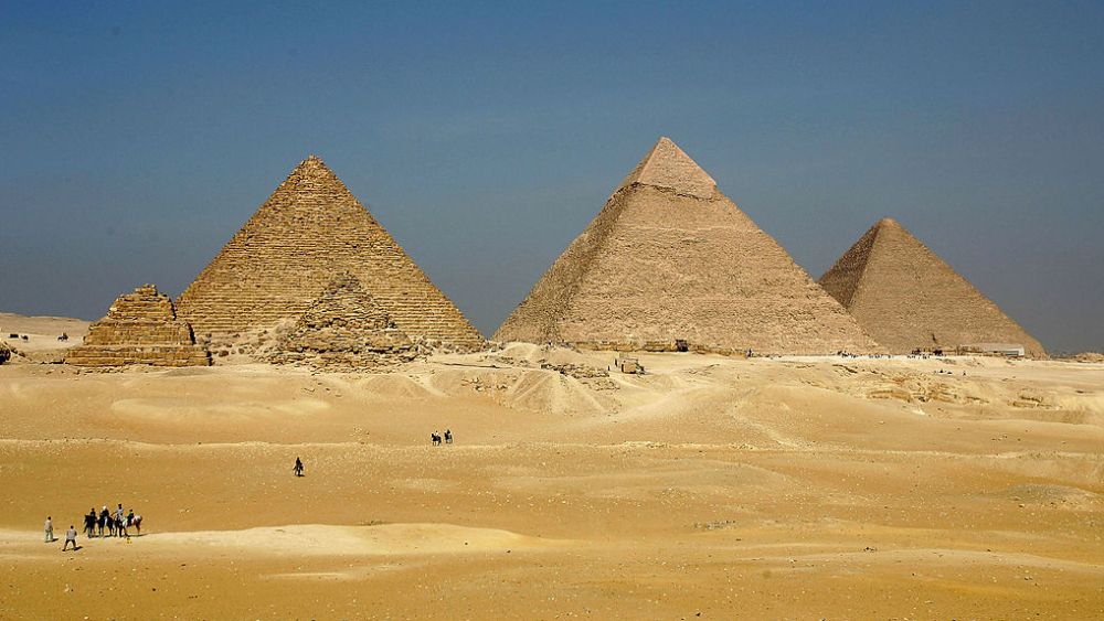GIZA, EGYPT - NOVEMBER 13: The three large pyramids of Menkaure (L), Khafre (C) and Khufu loom over the horizon November 13, 2004 at Giza, just outside Cairo, Egypt. The three large pyramids at Giza, built by King Khufu over a 30 year period around 2,550 B.C., are among Egypt's biggest tourist attractions.  (Photo by Sean Gallup/Getty Images)