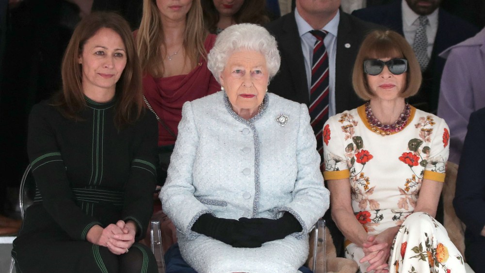 Britain's Queen Elizabeth II, accompanied by Chief Executive of the British Fashion Council (BFC), Caroline Rush (L) and British-American journalist and editor, Anna Wintour (R), views British designer Richard Quinn's runway show before presenting him with the inaugural Queen Elizabeth II Award for British Design, during her visit to London Fashion Week's BFC Show Space in central London on February 20, 2018. (Photo by Yui Mok / POOL / AFP) (Photo by YUI MOK/POOL/AFP via Getty Images)