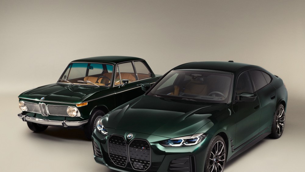 The old and the new BMW electric cars designed by Kith's Ronnie Fieg shown side by side in deep green on a plain tan background.